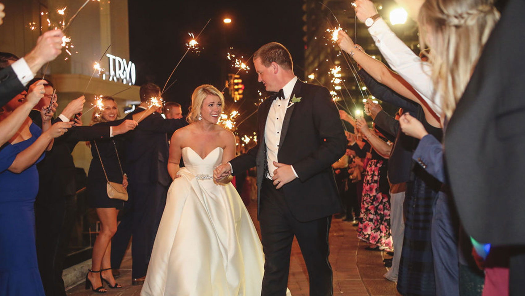 Newlyweds + attendees with sparklers