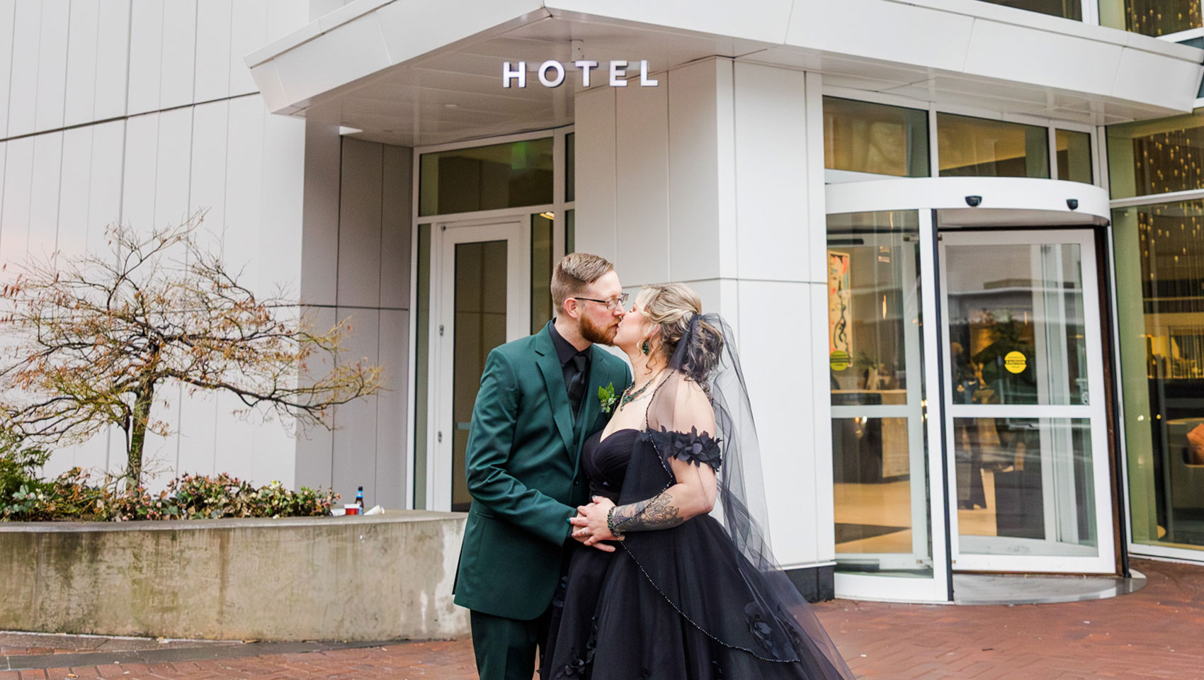 Newlyweds in front of hotel