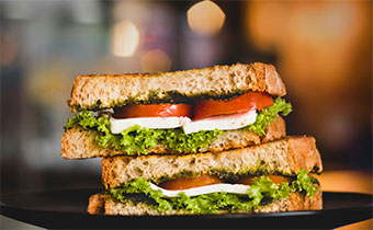 Sandwich with tomato, cheese, lettuce and pesto